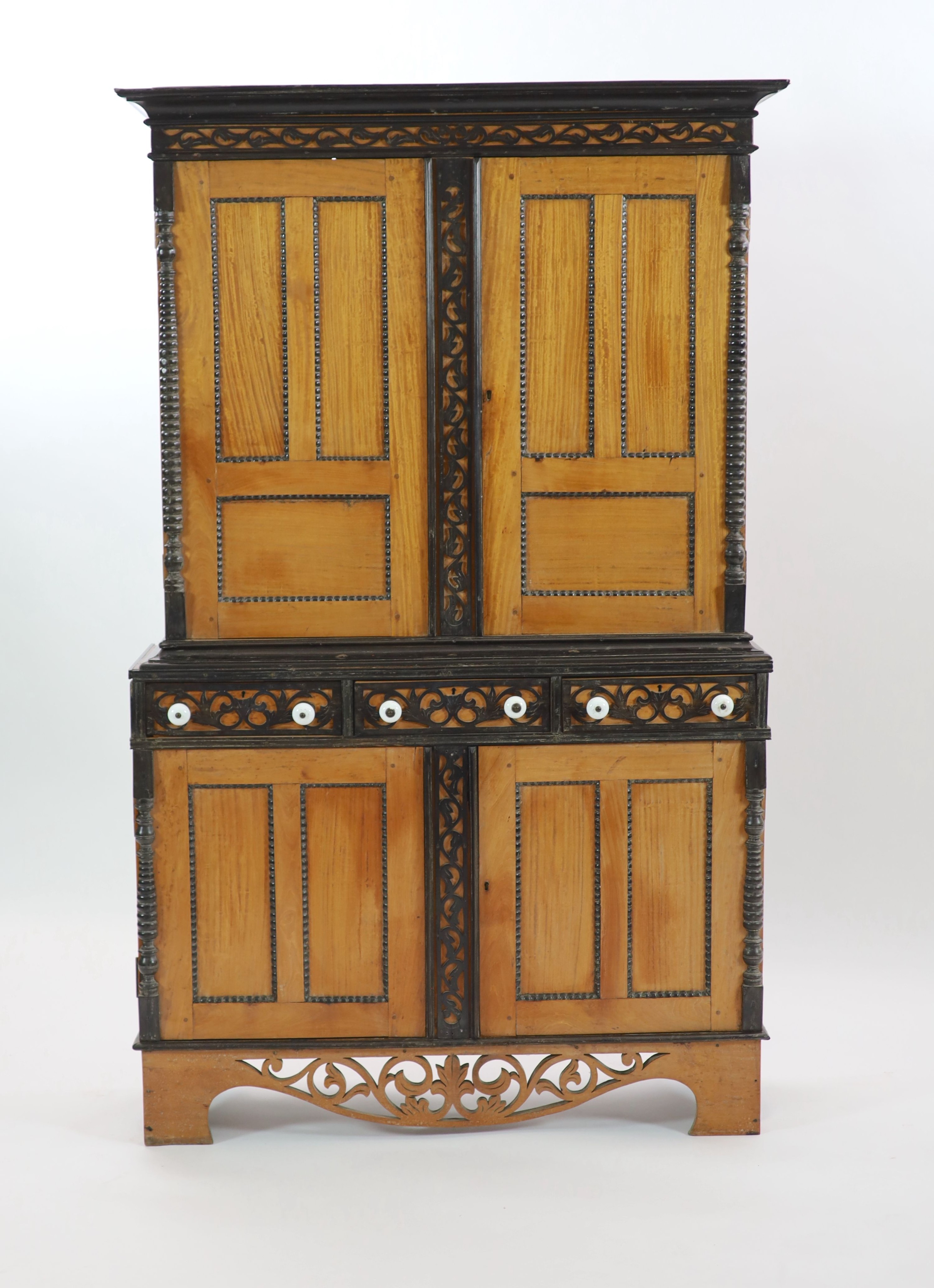 A mid 19th century Ceylonese satinwood and ebony side cabinet, H 194cm. W 120cm. D 37cm.